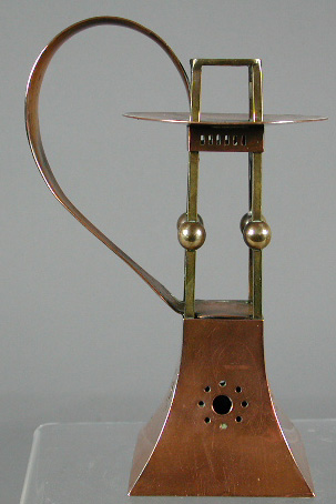 An Austrian Art Nouveau brass and copper chamber candlestick