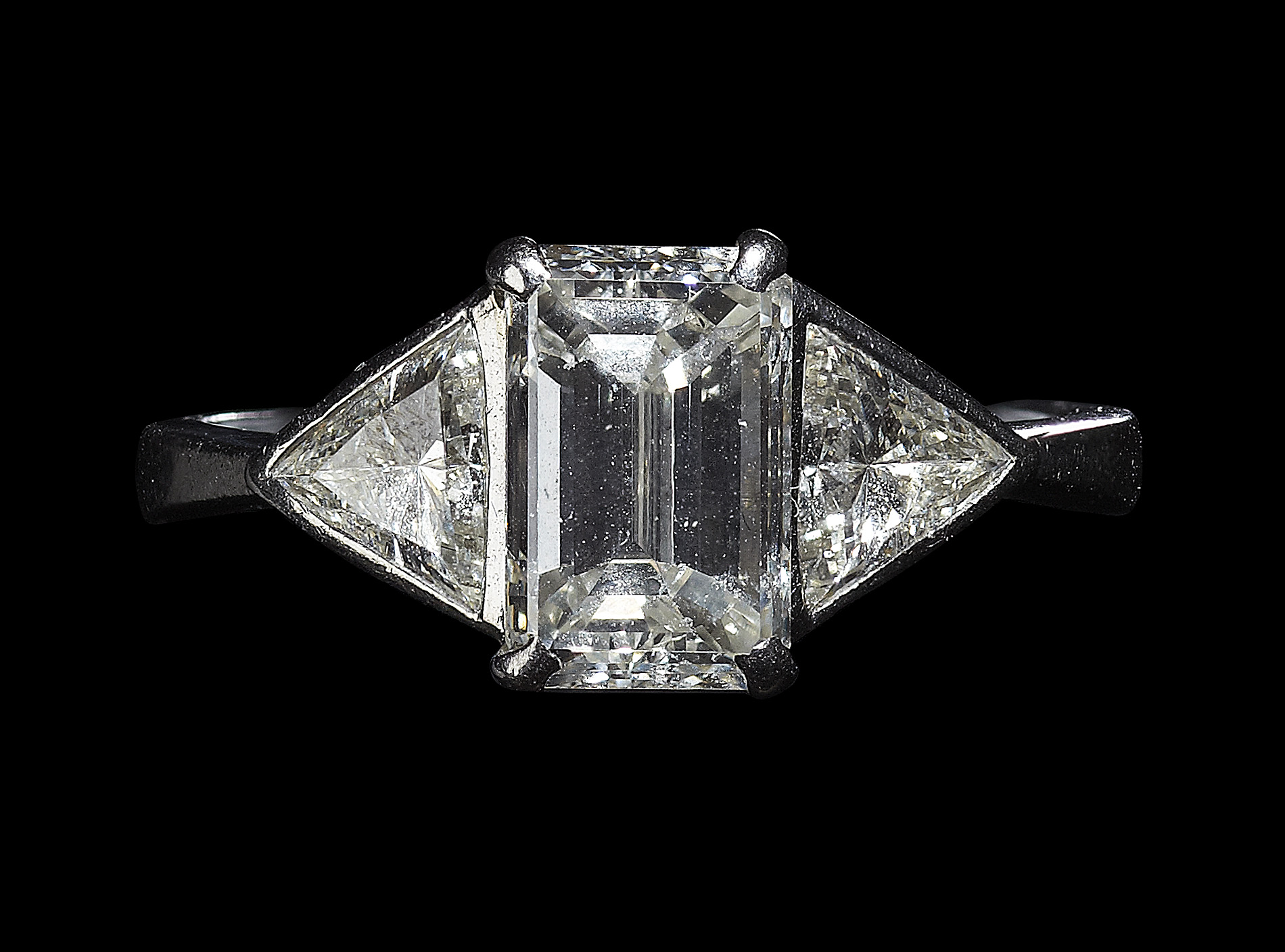 A platinum mounted diamond three-stone ring