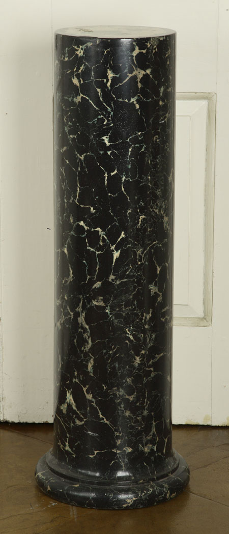 A simulated marble ceramic pedestal