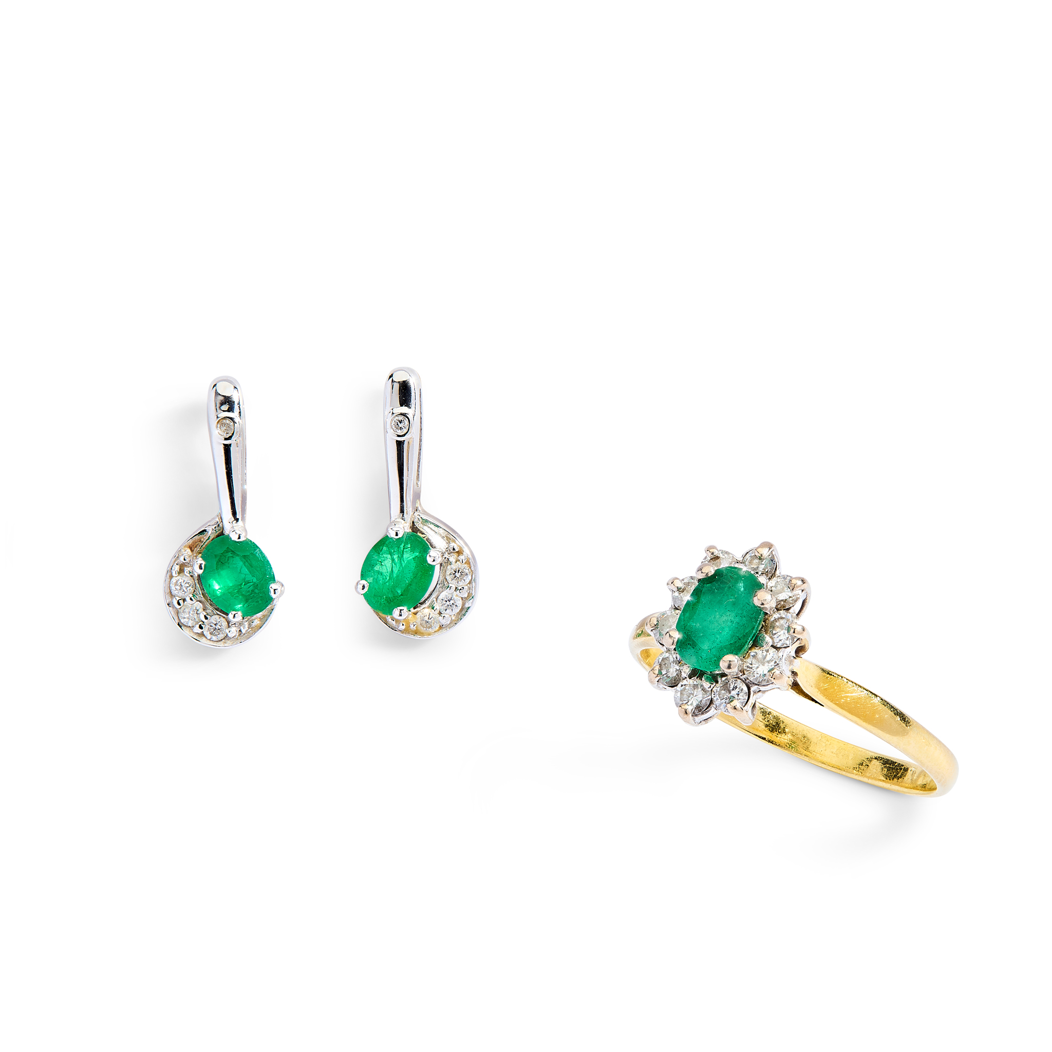 An emerald and diamond ring and earrings
