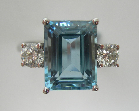 An aquamarine and diamond three-stone ring,
