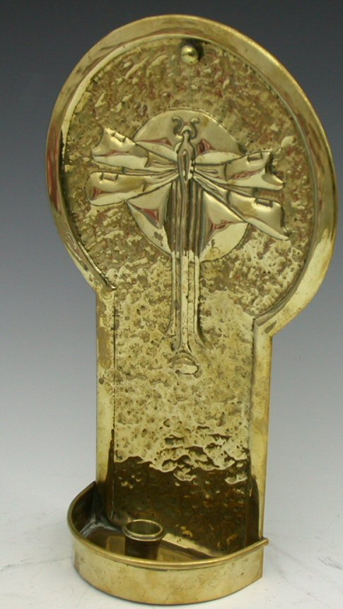 A Scottish Arts and Crafts brass candle sconce,