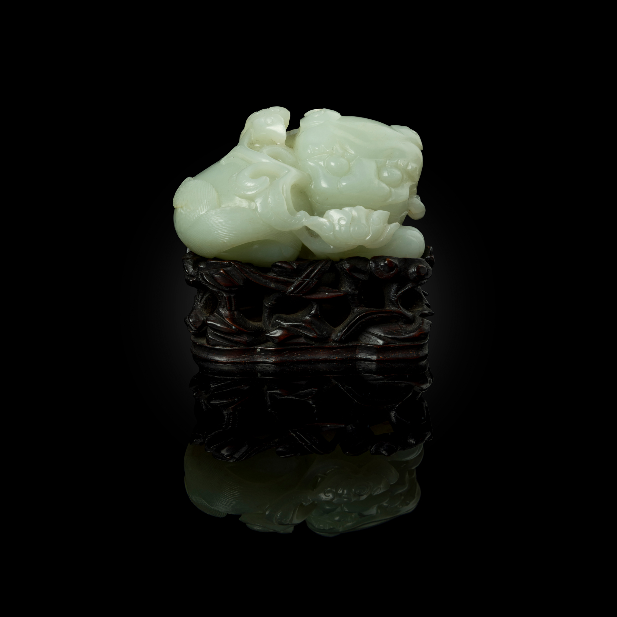 CHINESE PALE CELADON JADE CARVING OF A BUDDHIST LION