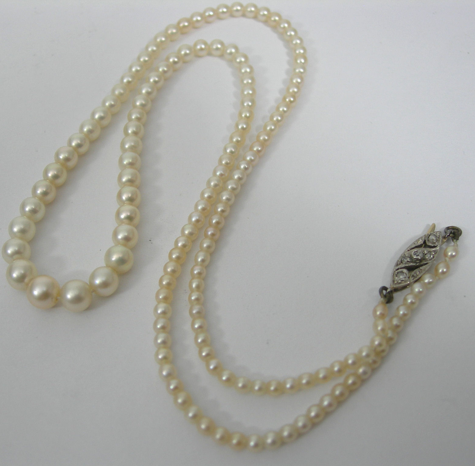 A cultured pearl necklace with diamond set clasp,