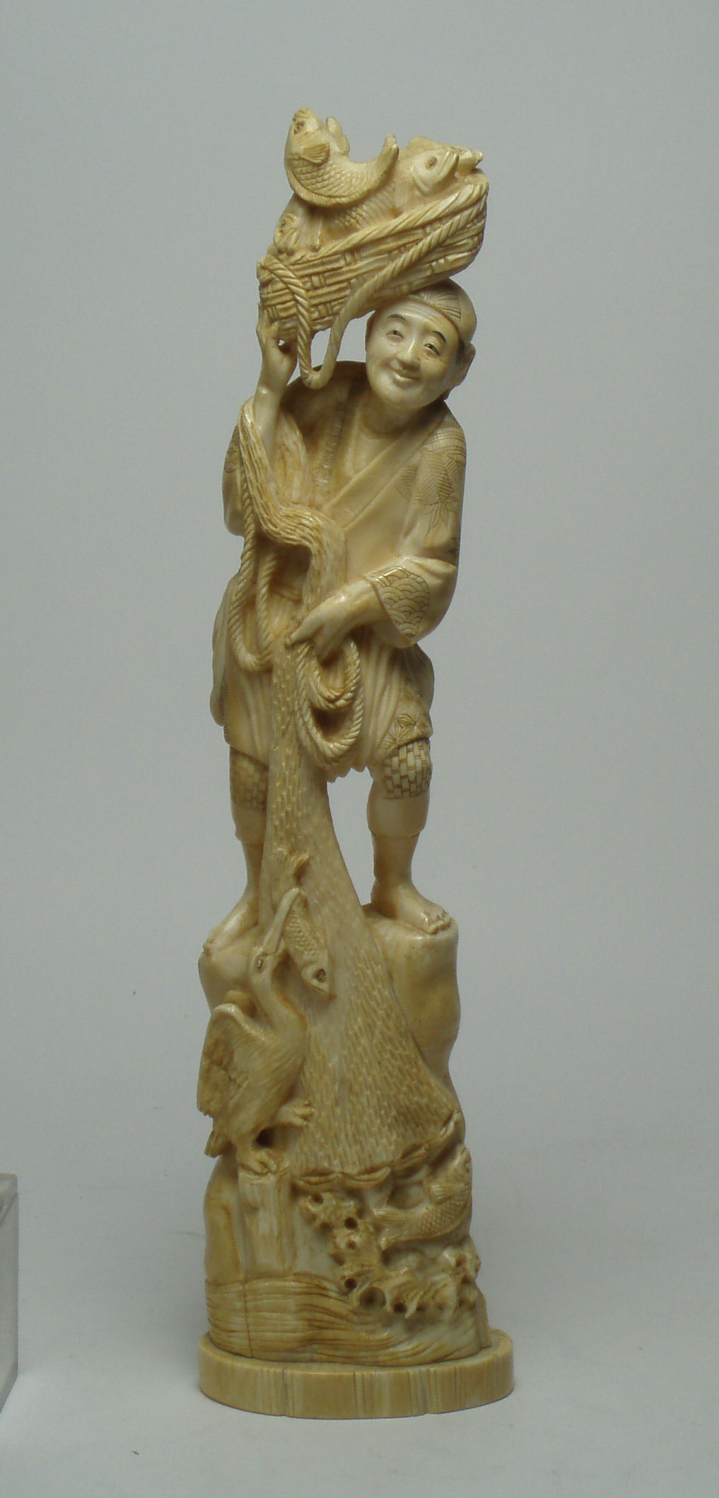A Japanese ivory figure of a fisherman
