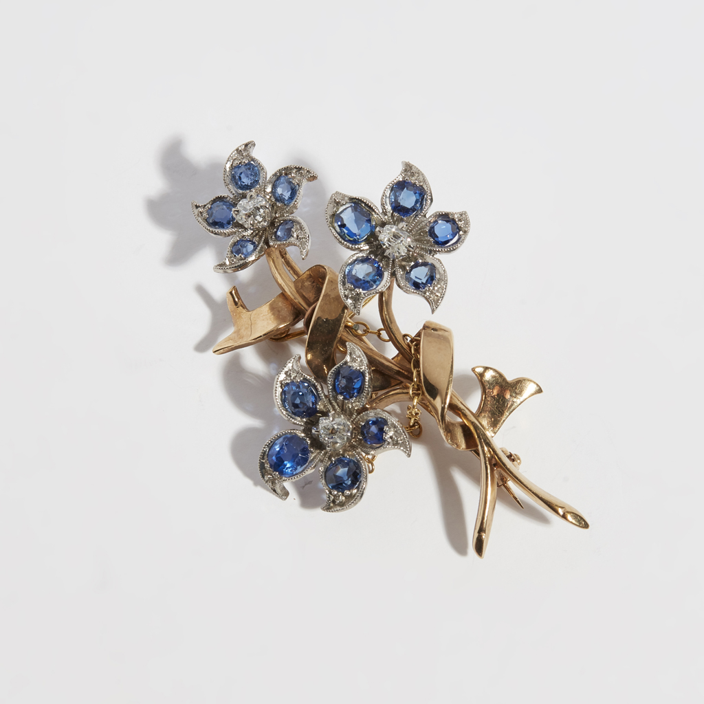 A sapphire and diamond set floral spray brooch