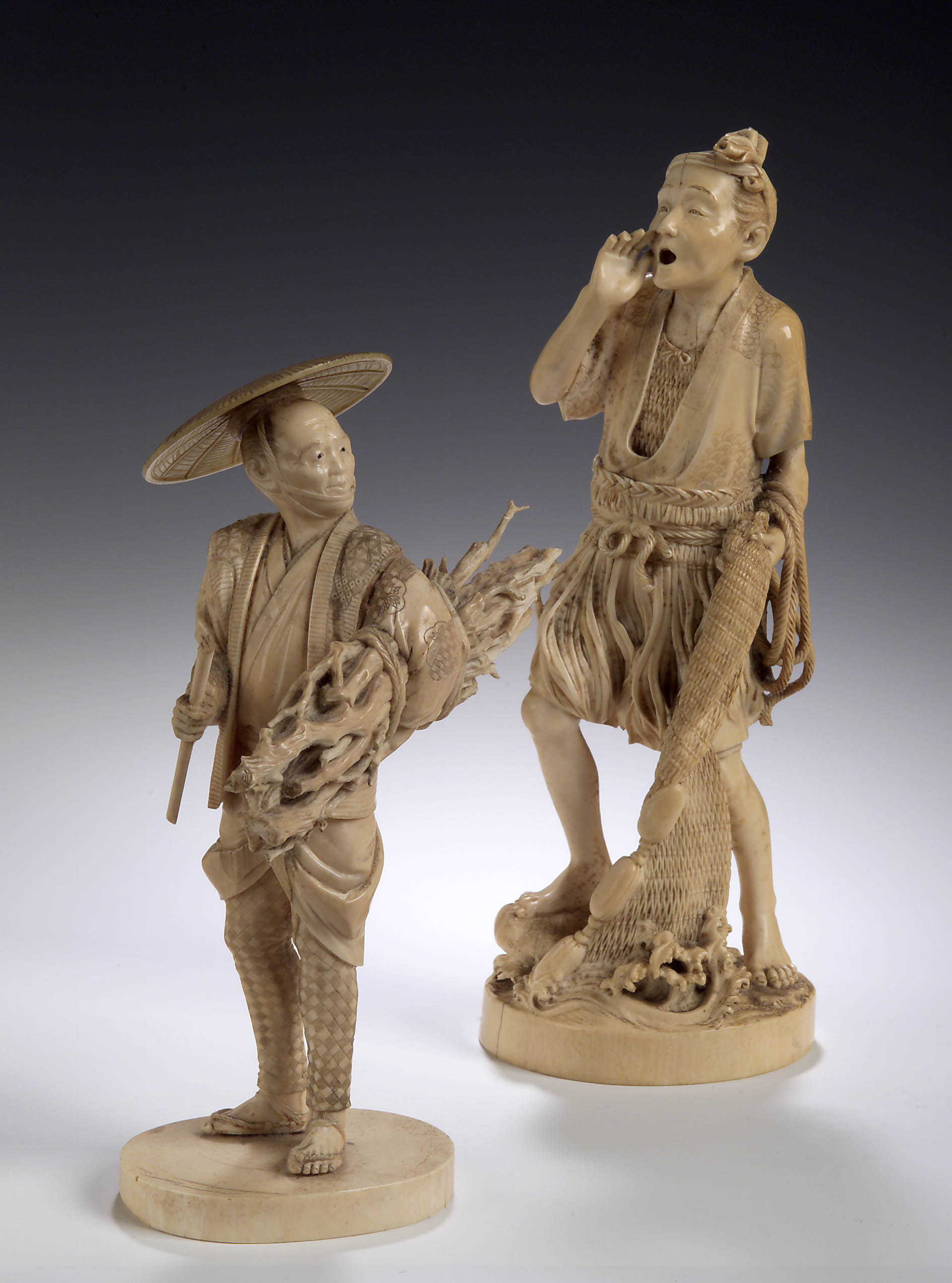A large Japanese carved ivory figure of a fisherman