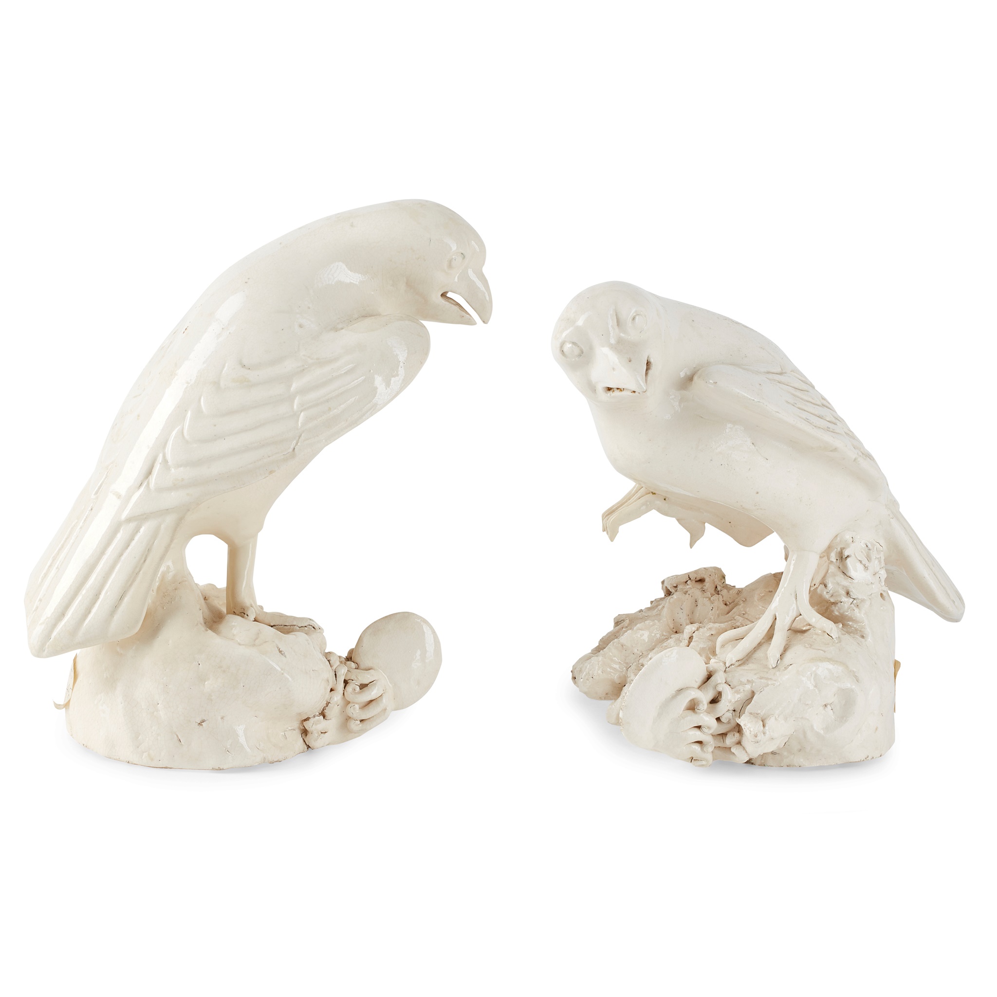 PAIR OF CONTINENTAL WHITE GLAZED POTTERY SEA HAWKS