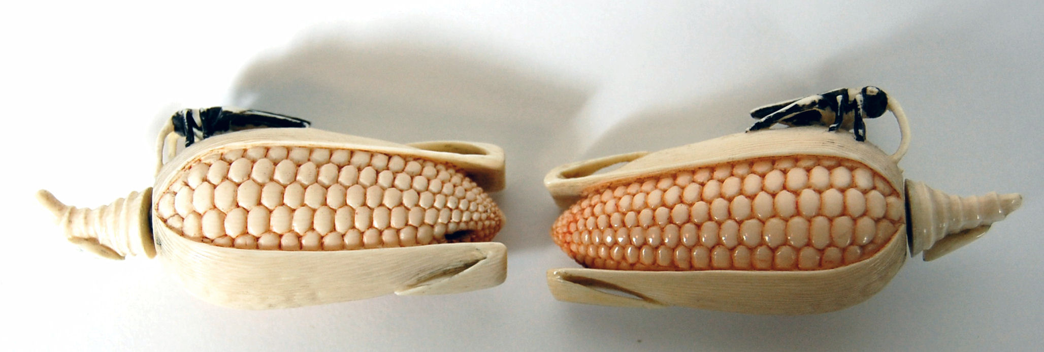 A pair of early 20th century Chinese ivory snuff bottles and covers