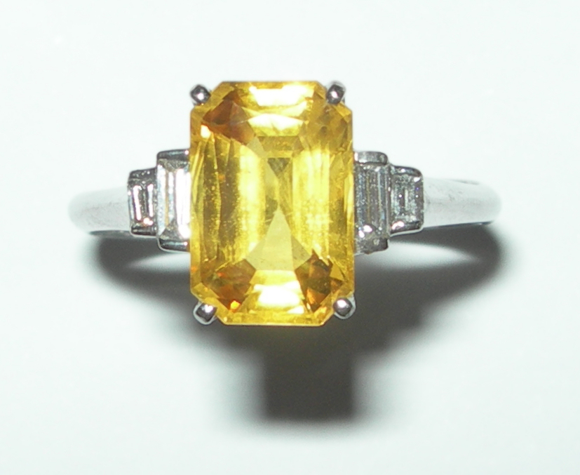 An Art Deco style yellow sapphire and diamond set ring,