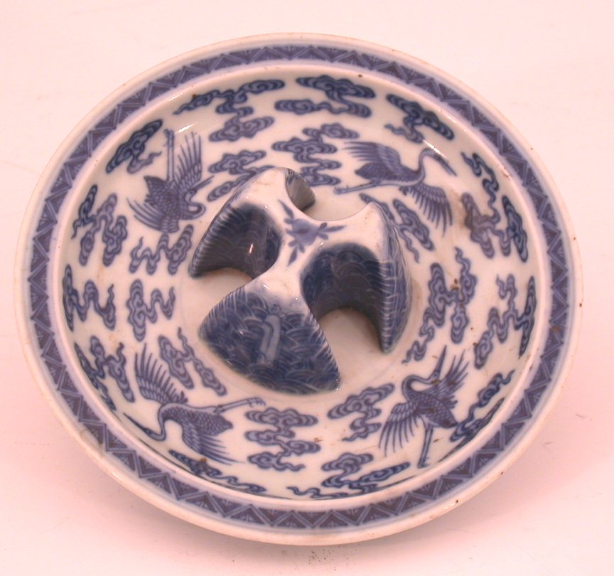 A Chinese blue painted circular lemon squeezer,