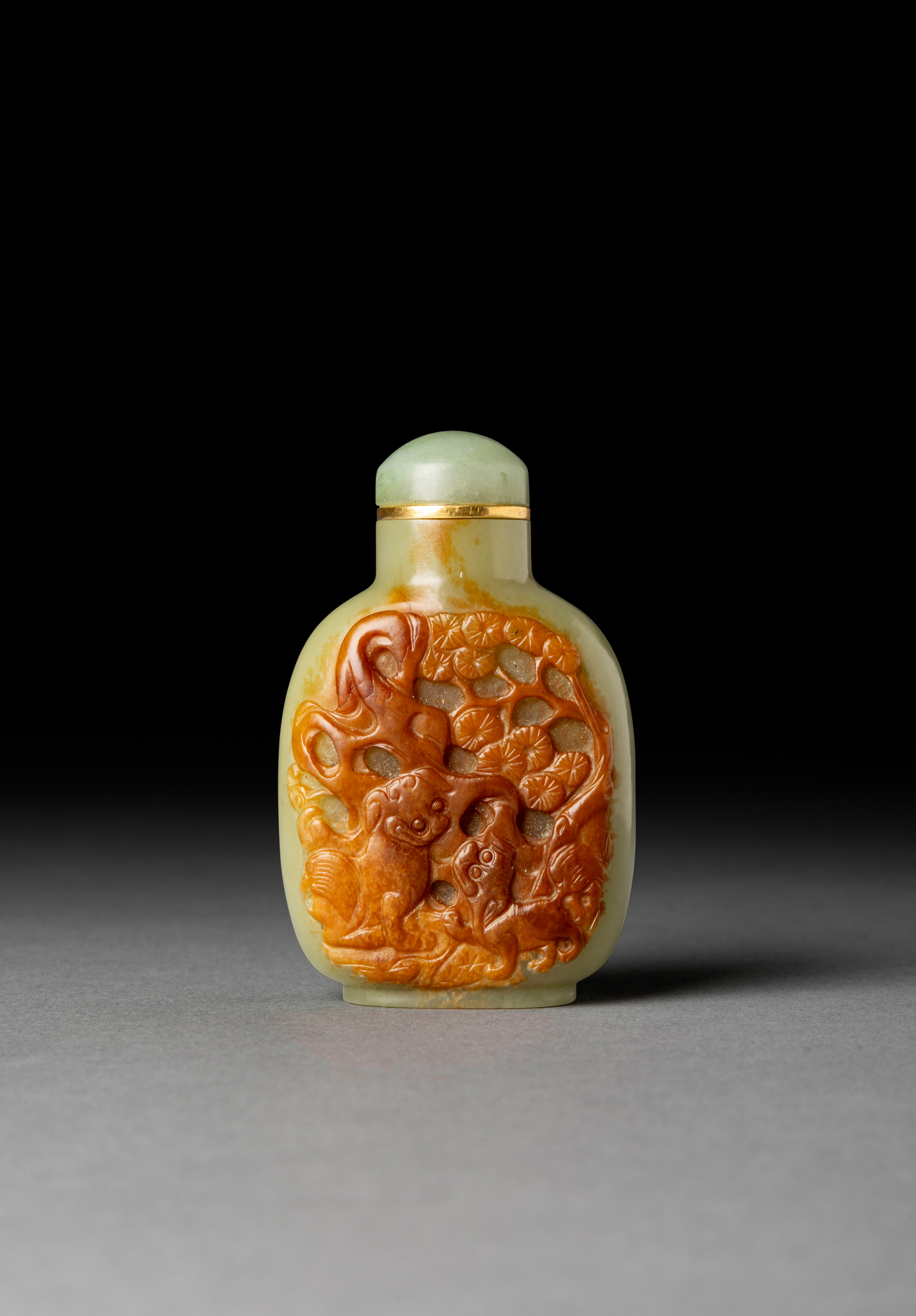 [COLLECTION OF PROF. J. GILBERT & CORA MCALLISTER] CHINESE YELLOW JADE WITH RUSSET SKIN 'BUDDHIST LION' SNUFF BOTTLE