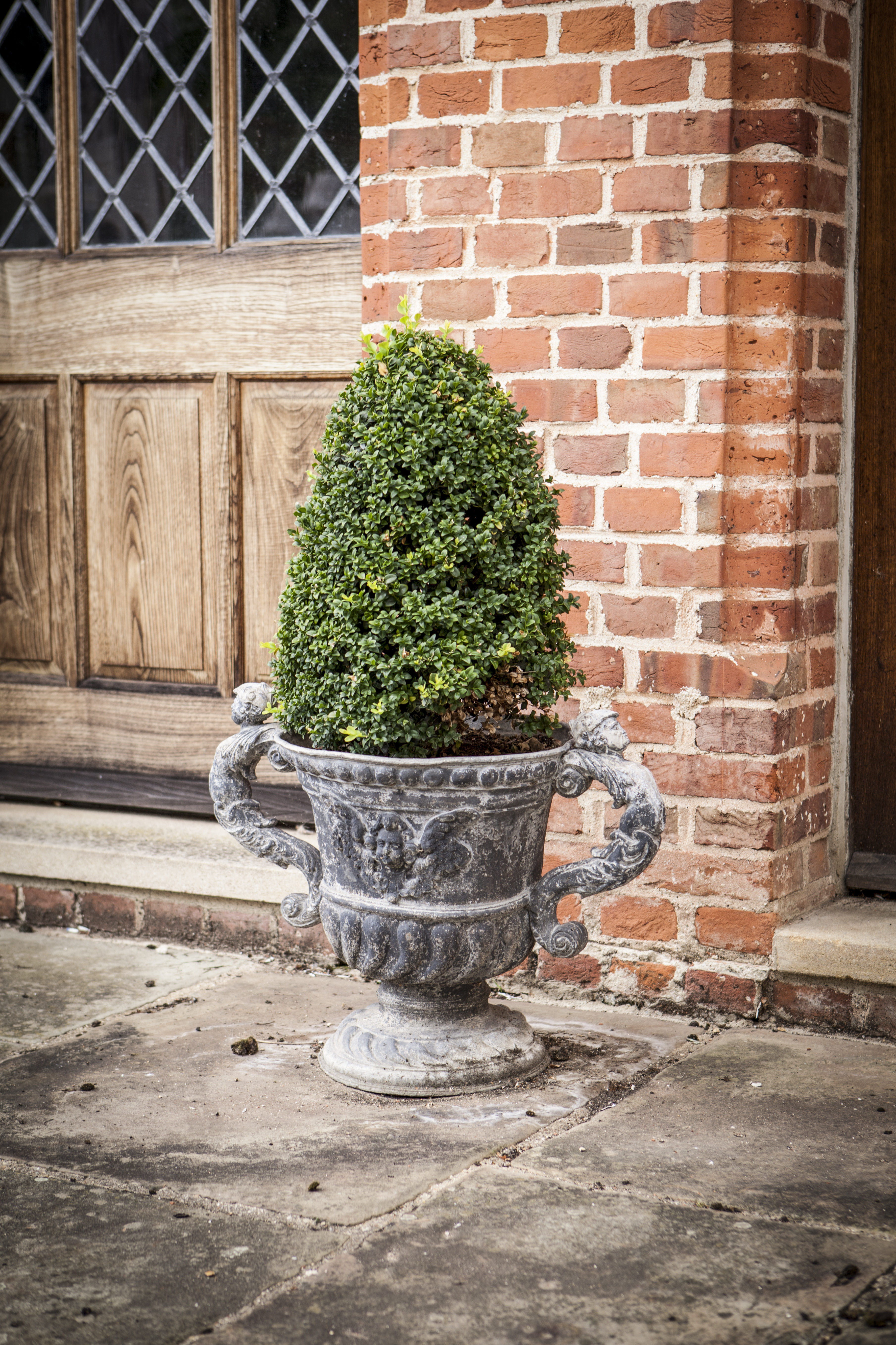 THREE SIMILAR BAROQUE STYLE LEAD URNS