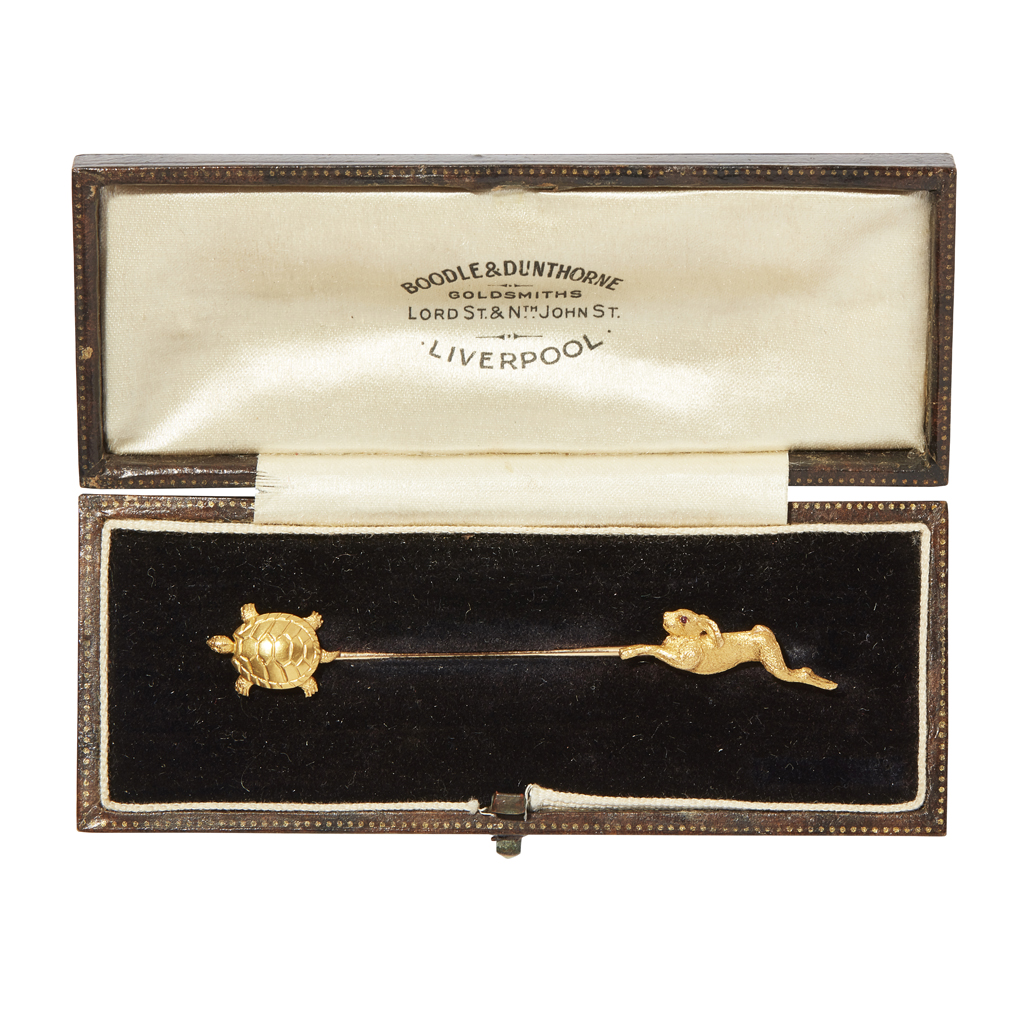 A novelty tortoise and hare stick pin