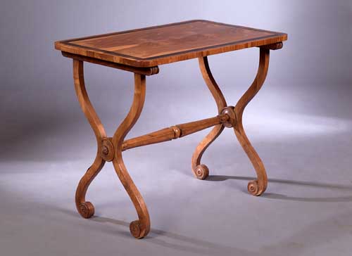 An early 19th century chestnut and rosewood banded table