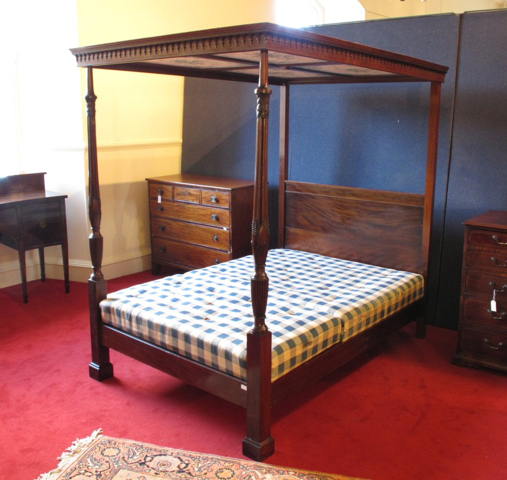 A carved mahogany four poster bed