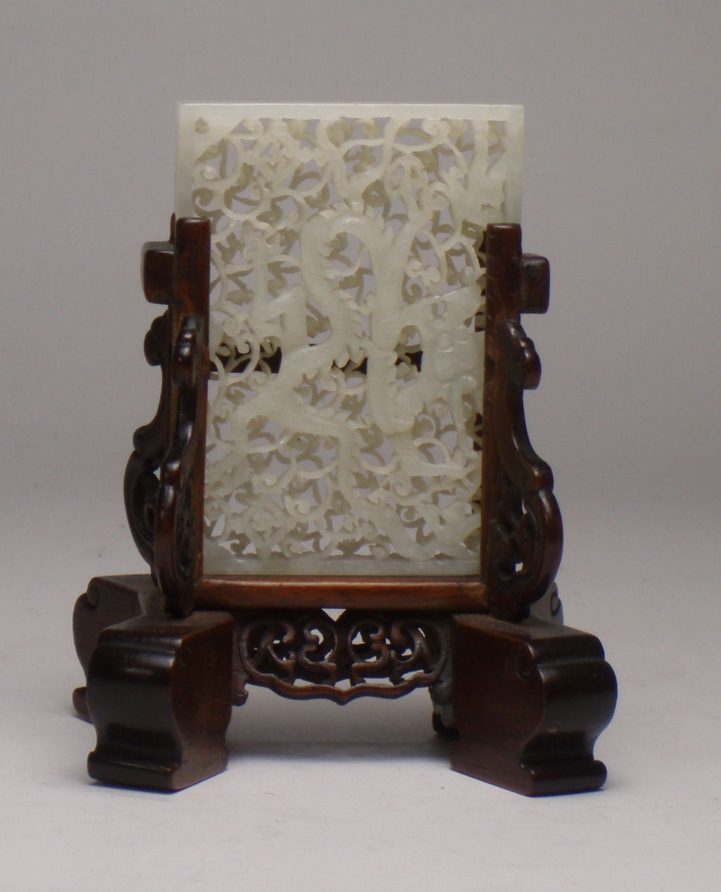 A Chinese white jade reticulated screen of a dragon