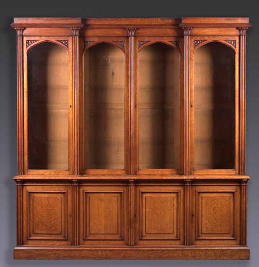 A late Victorian oak inverted breakfront bookcase