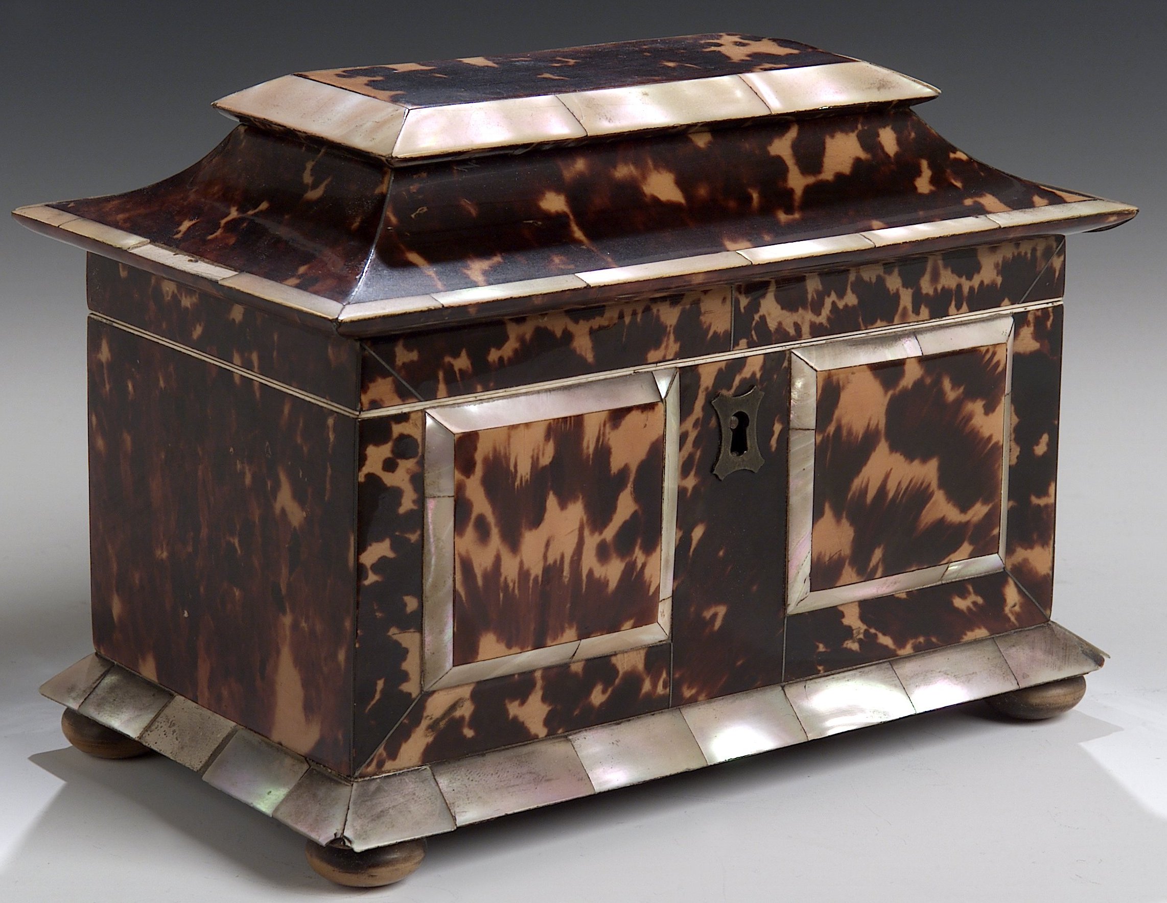 An early 19th century tortoiseshell and mother of pearl tea caddy