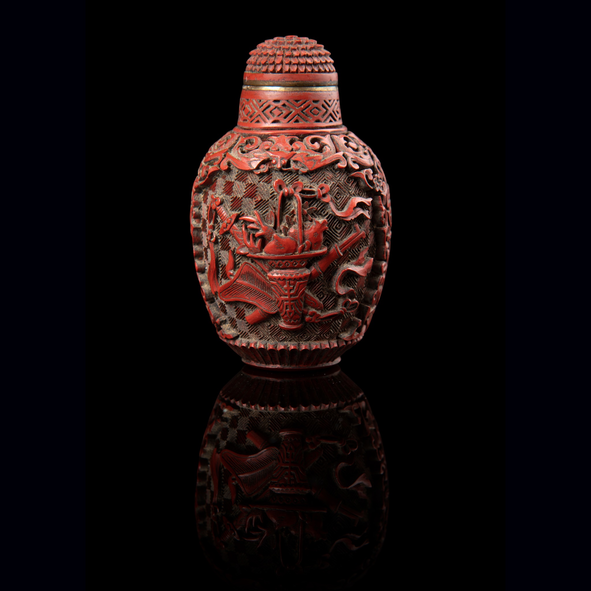 CARVED CINNABAR LACQUER 'EIGHT DAOIST EMBLEMS' SNUFF BOTTLE