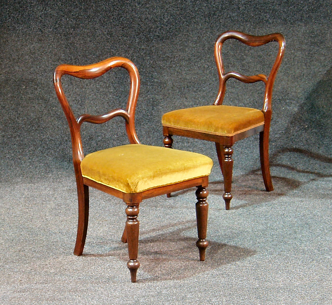 A set of five Victorian rosewood balloon back chairs