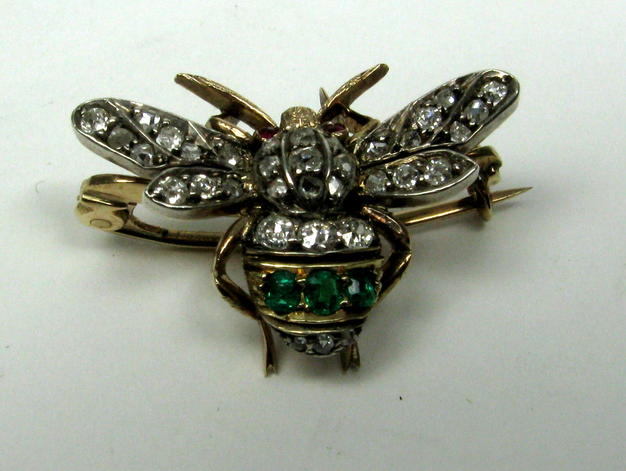 A good cased set of four Edwardian diamond and gem set bumble bee brooches