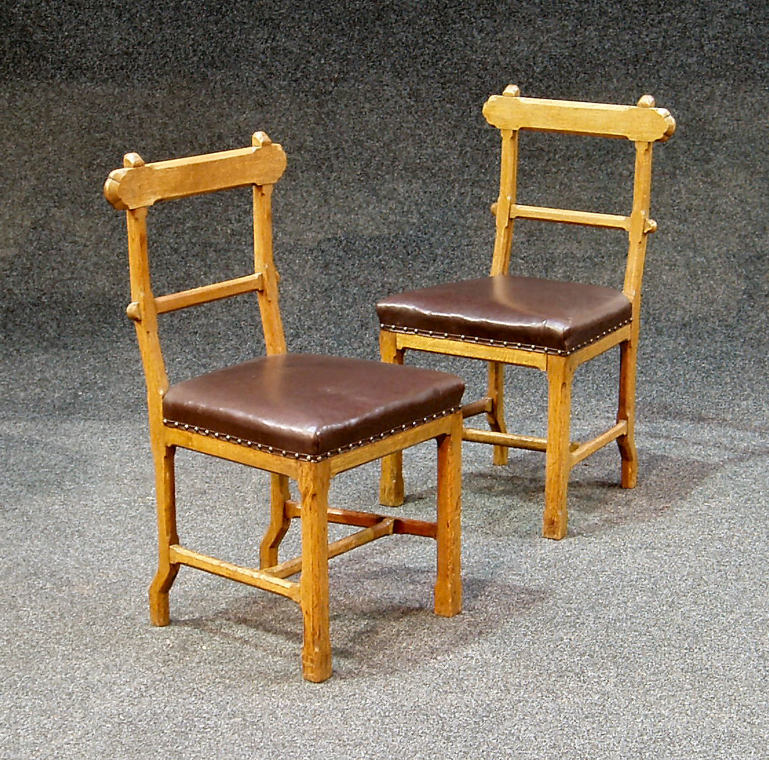 A set of twelve oak Gothic style dining chairs