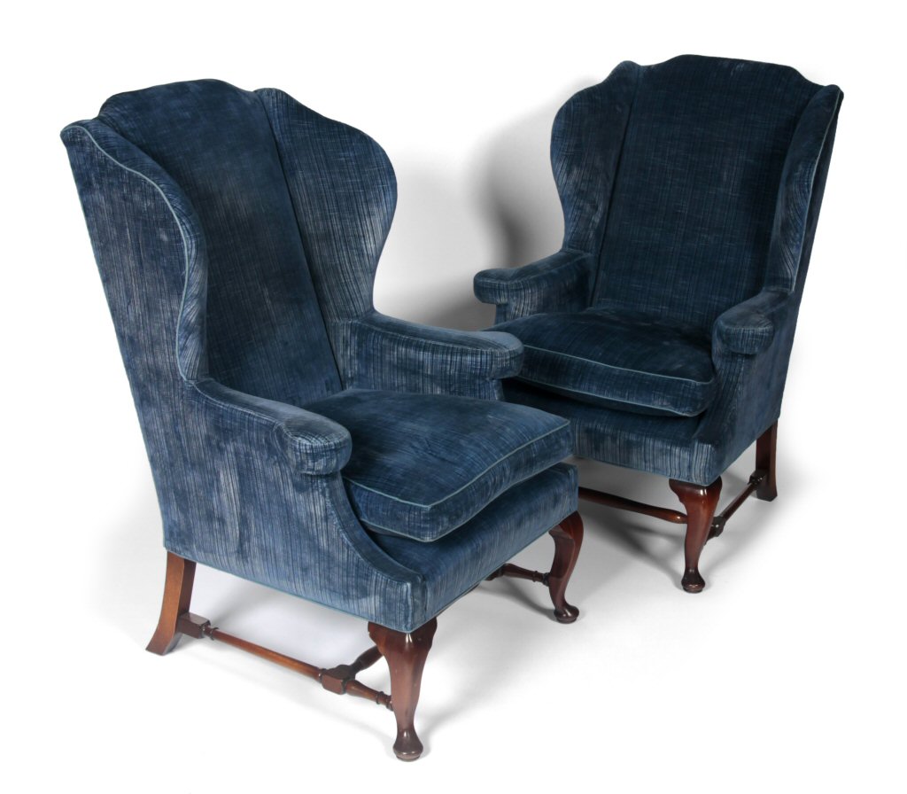A pair of Queen Anne style wing back arm chairs