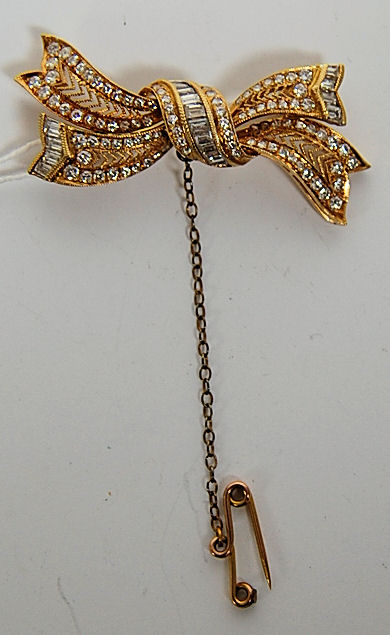 A modern diamond set bow brooch,
