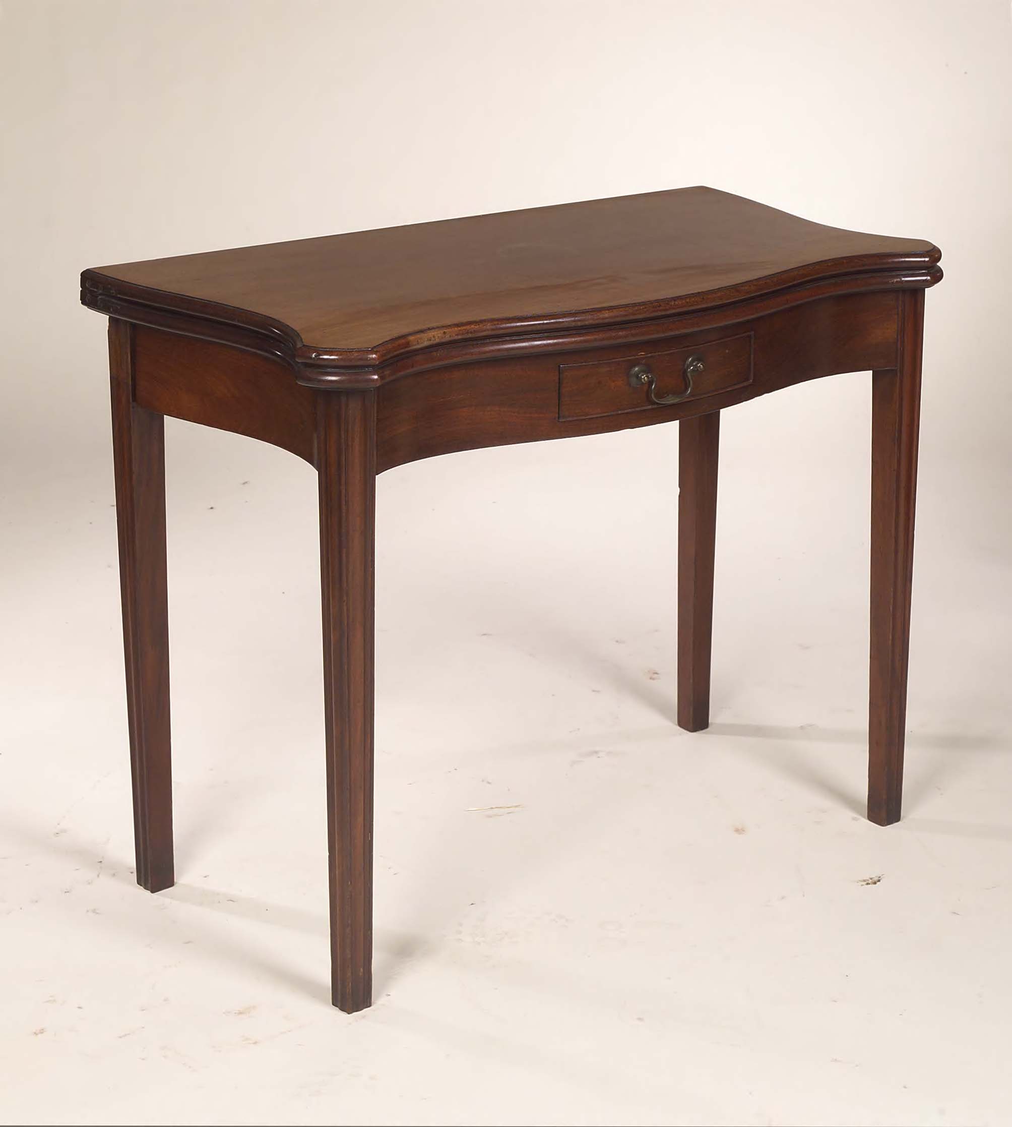 A George II mahogany foldover tea table,