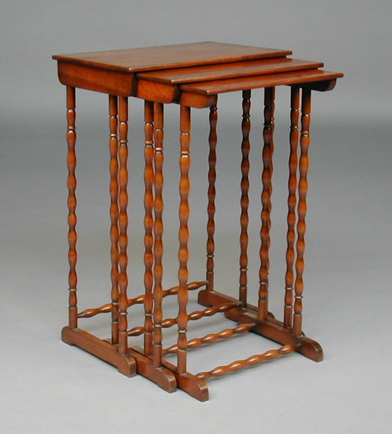 An early 20th century nest of three mahogany tables