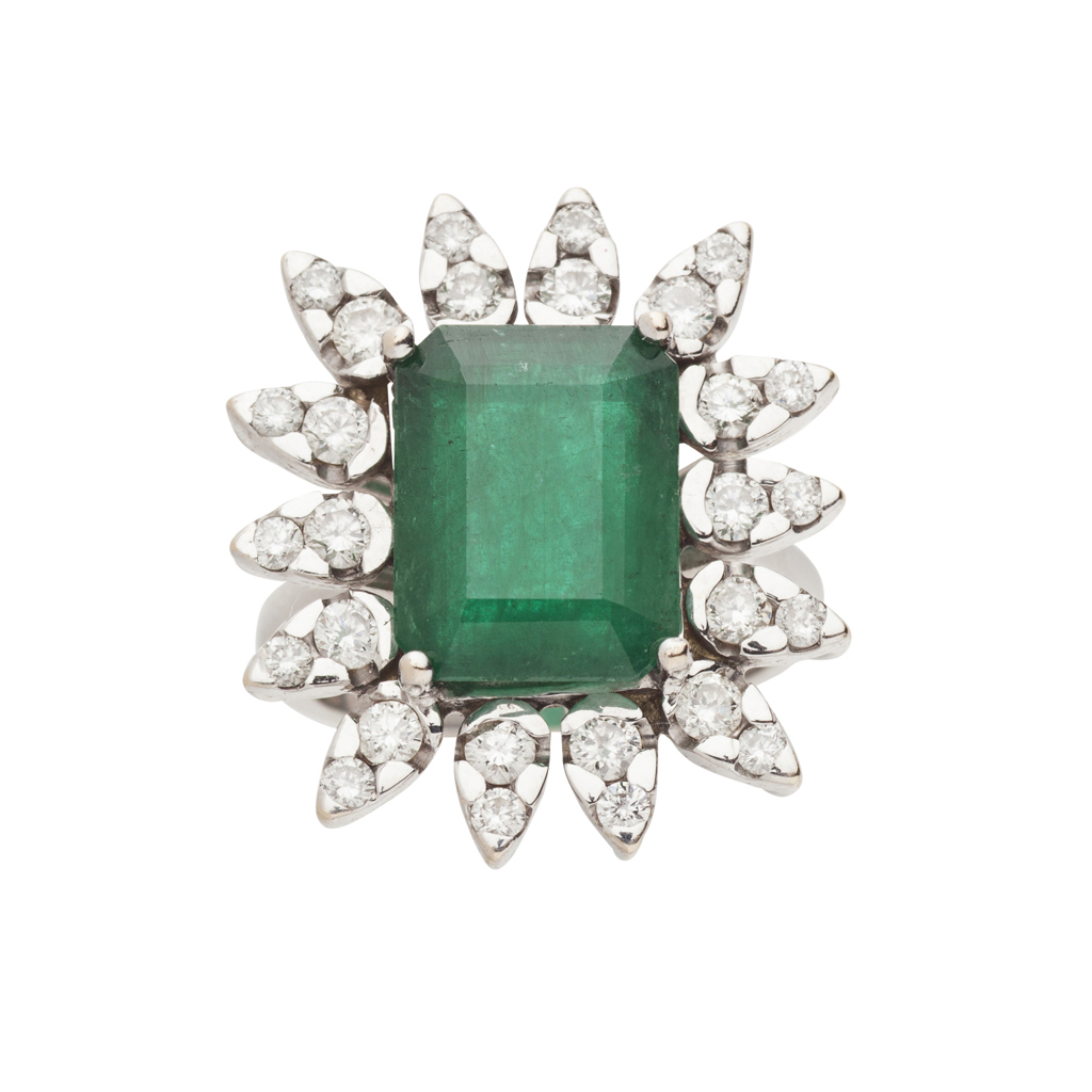 An emerald and diamond cluster ring