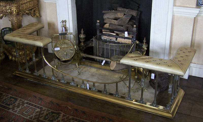 A large brass club fender