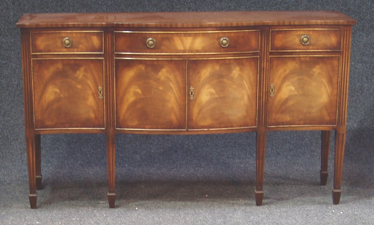 A Reproduction George III style flame mahogany and line inlaid dining suite,