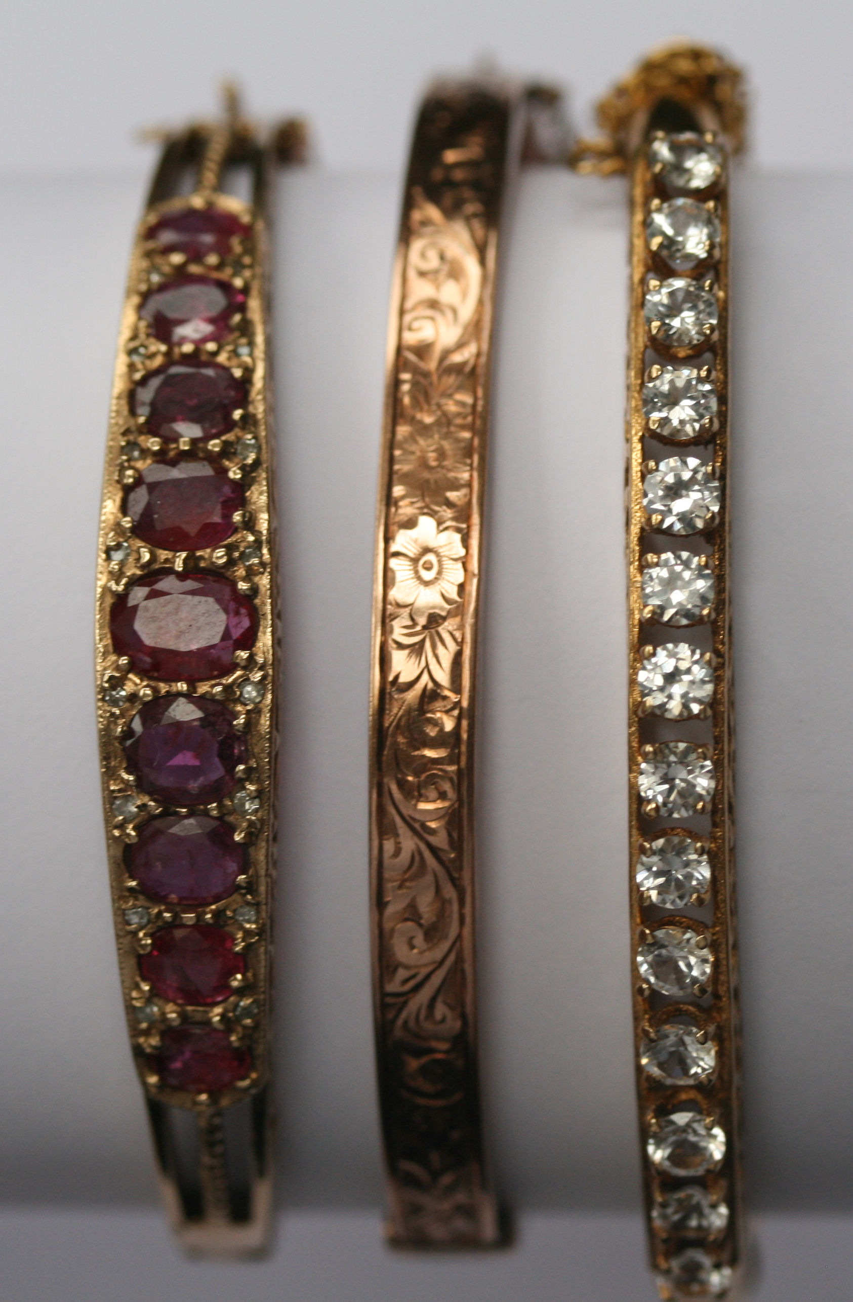 A group of three hinged gem set bangles