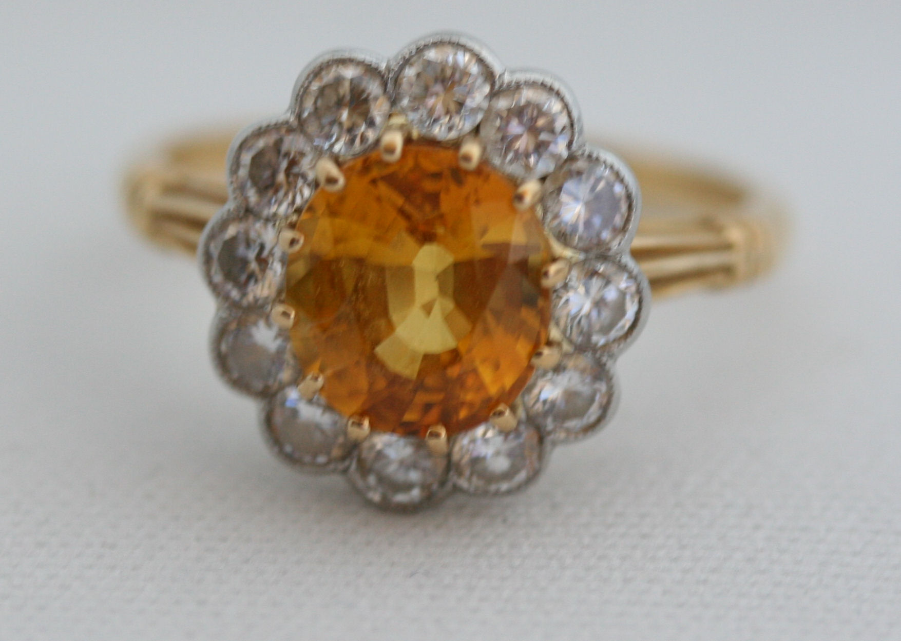 A modern yellow sapphire and diamond cluster ring,