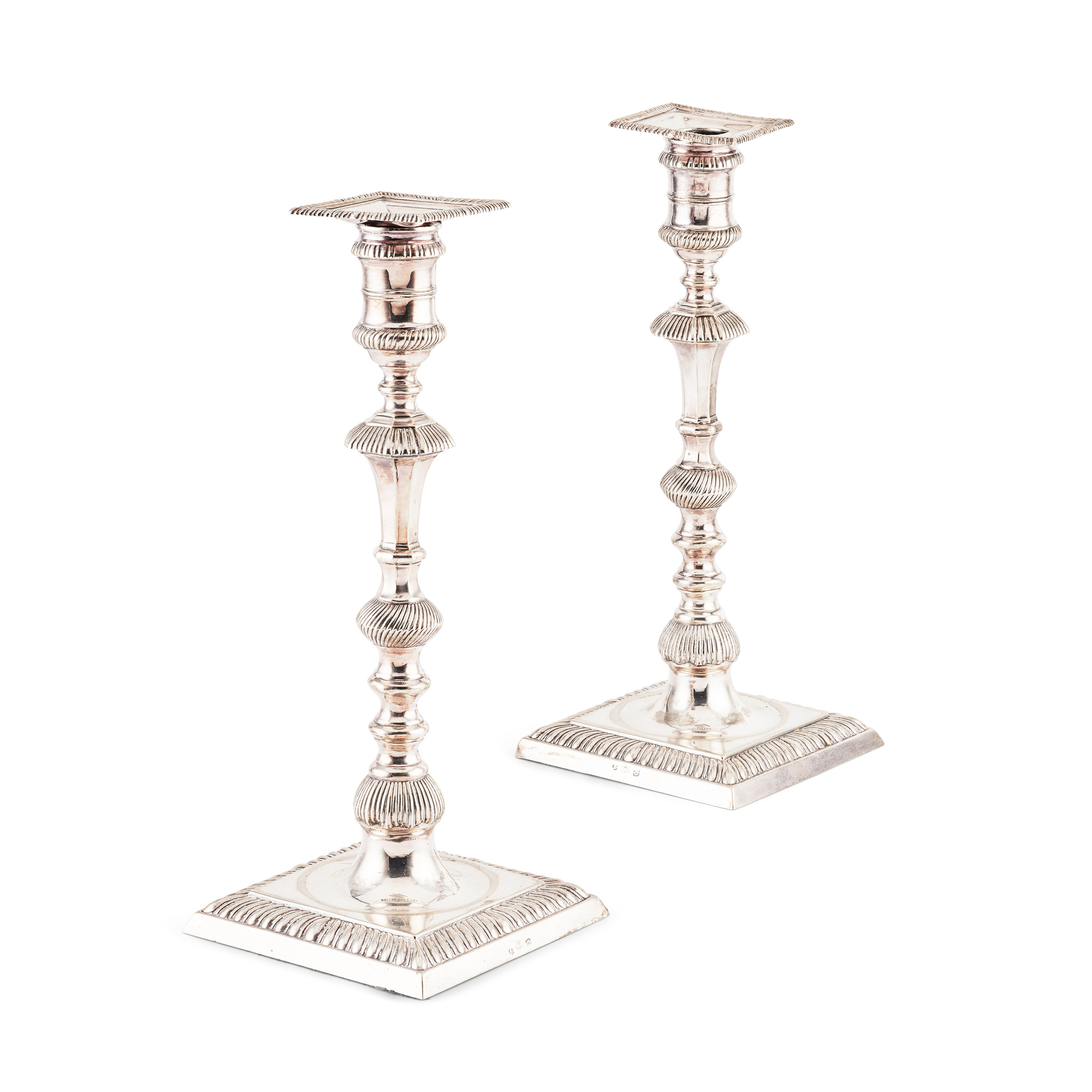 A PAIR OF CAST GEORGE III CANDLESTICKS