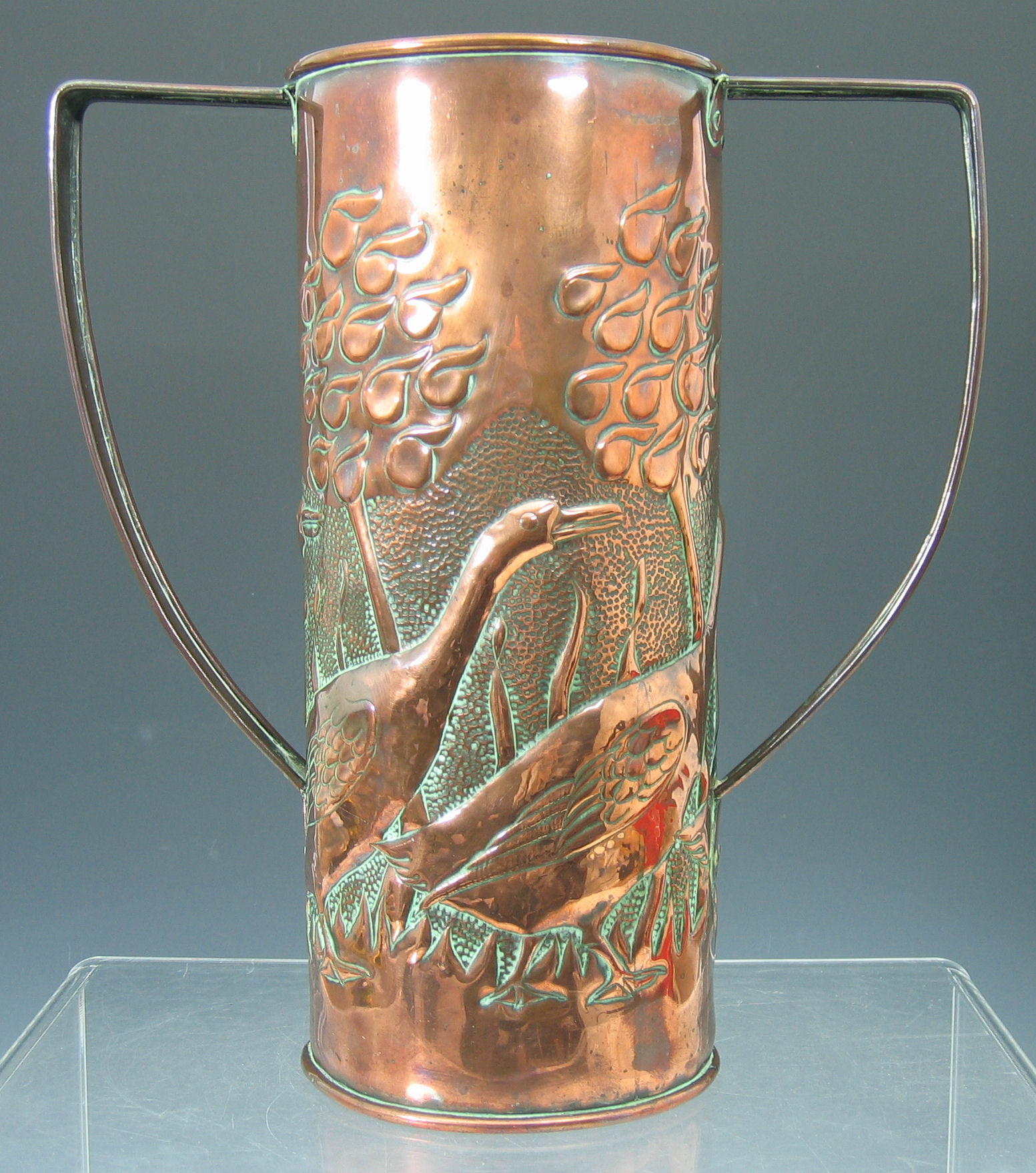 A Newlyn style twin-handled copper vase,