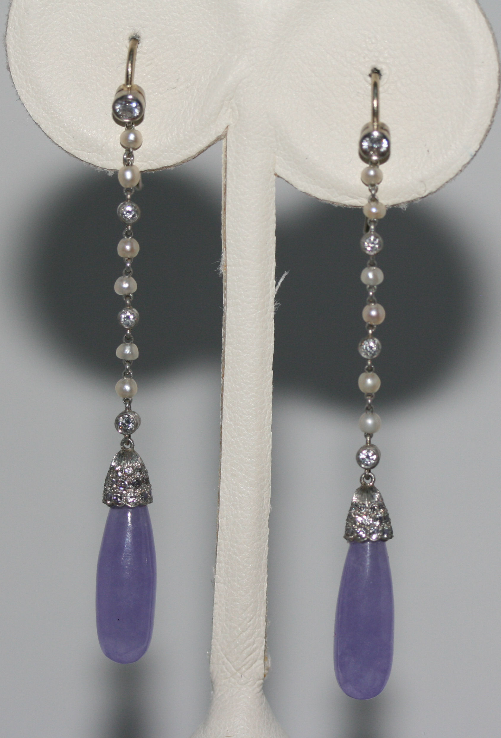 A pair of lavender jade and diamond pendant earrings