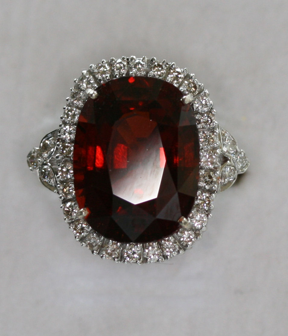 An 18ct white gold mounted garnet and diamond set ring