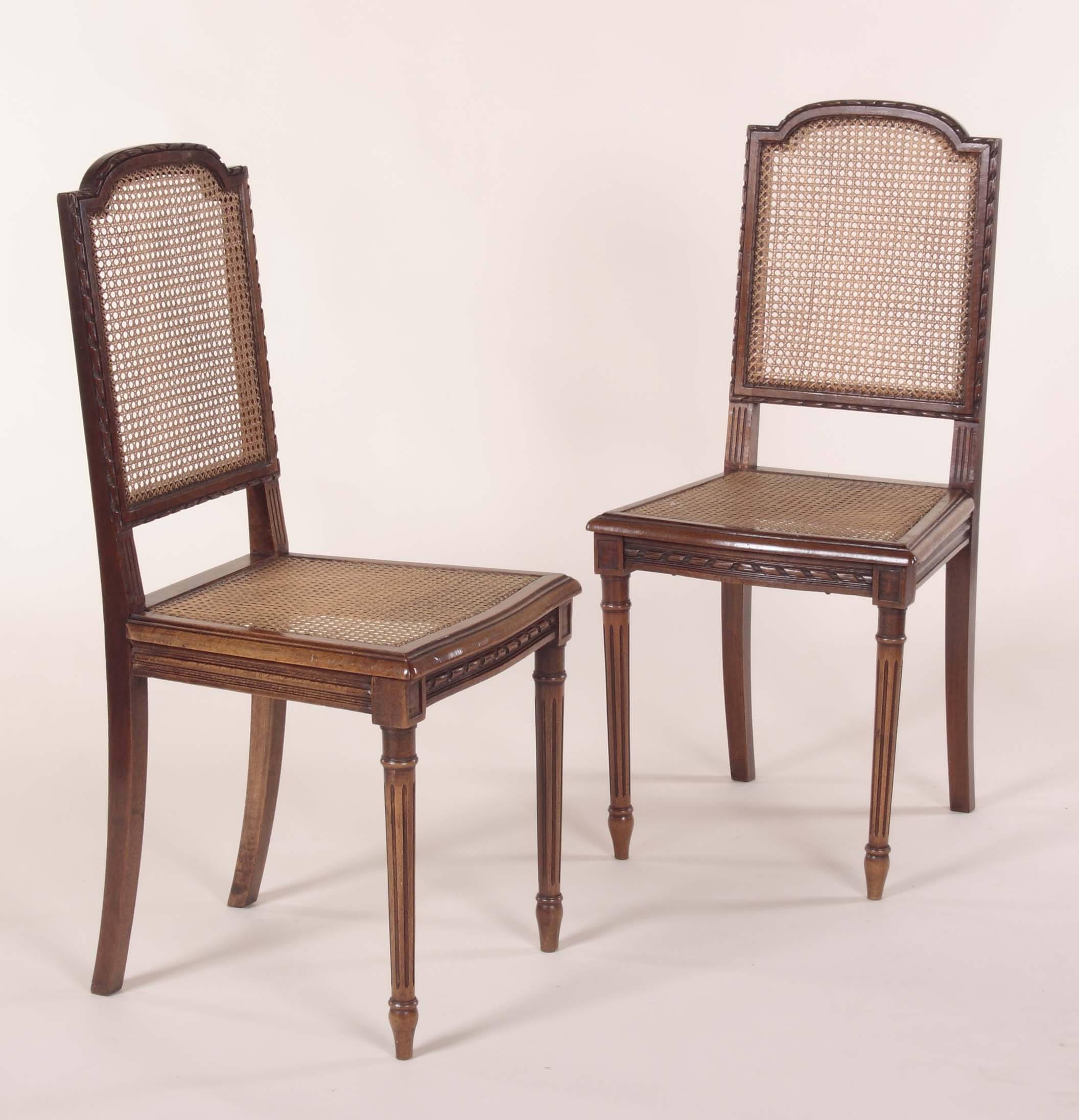 A set of six French walnut caned side chairs