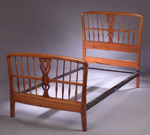 A pair of yew wood single bed ends by Heal and Sons
