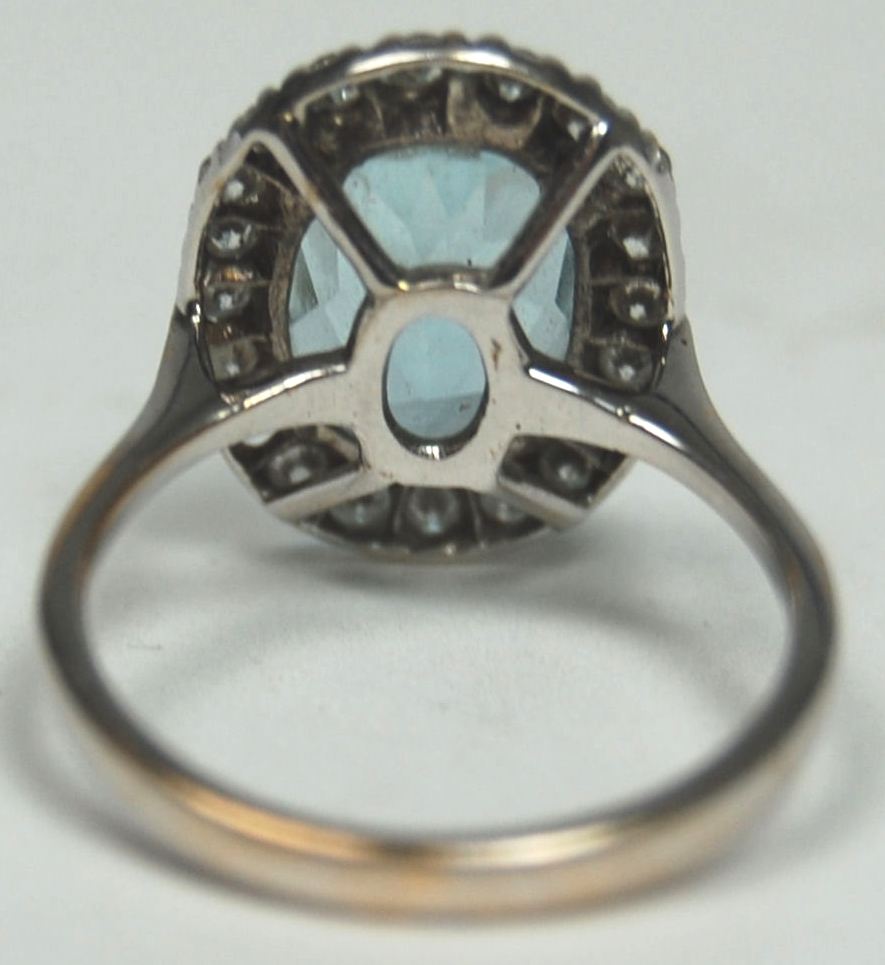 An aquamarine and diamond oval cluster ring,