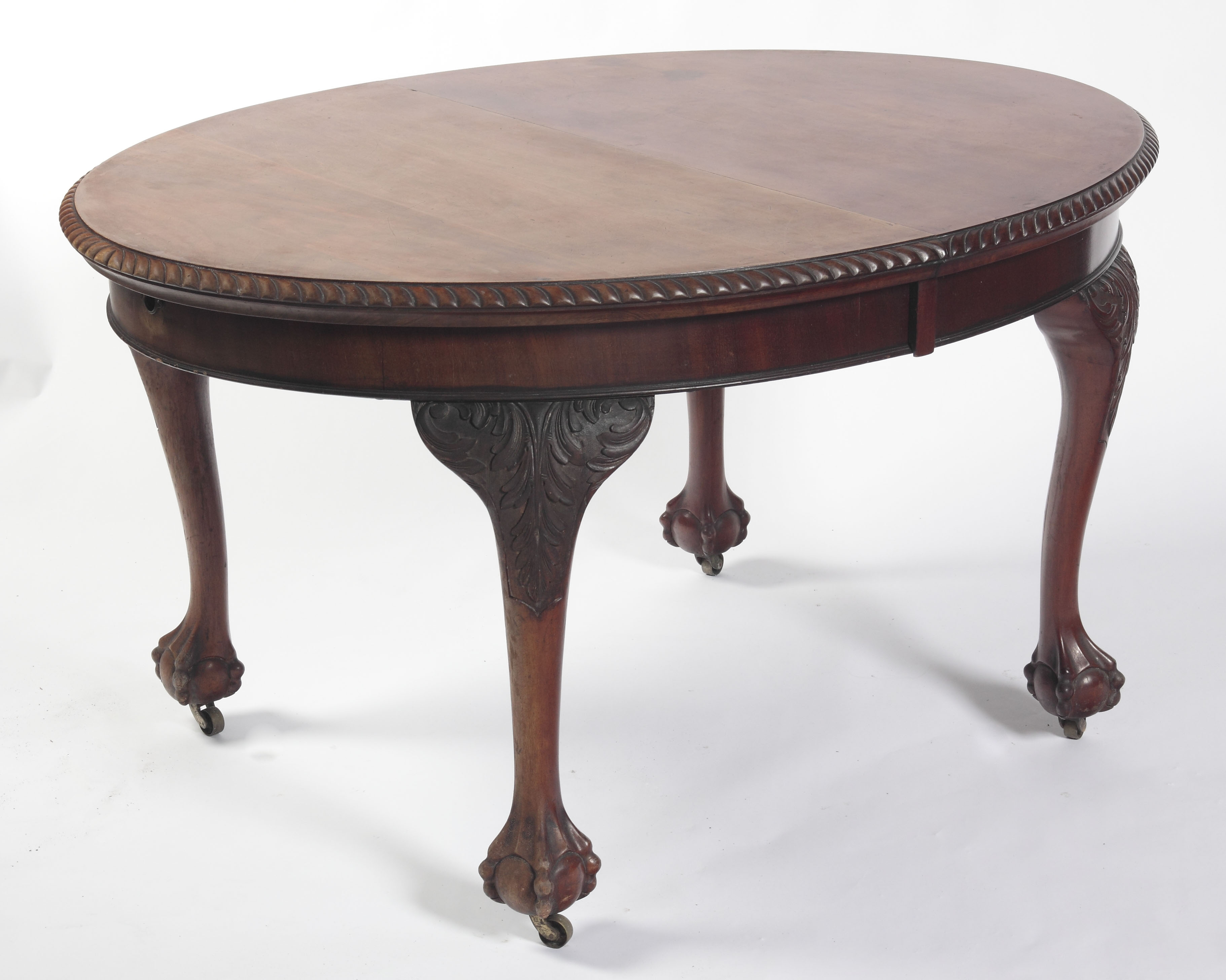An Edwardian mahogany extending dining table