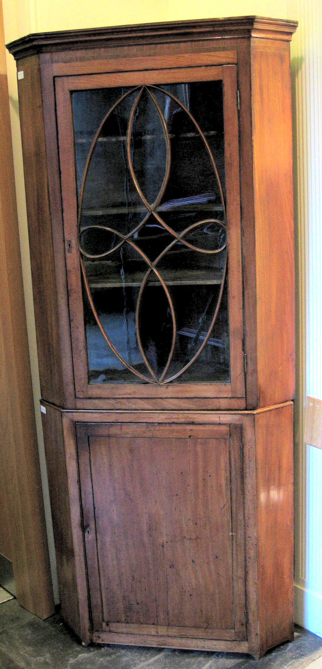 A George III mahogany corner cabinet,