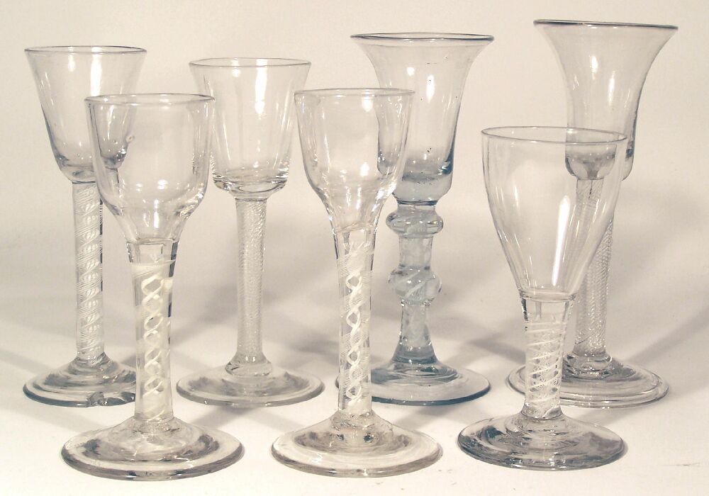 A group of seven English mid 18th century enamel twist wine glasses