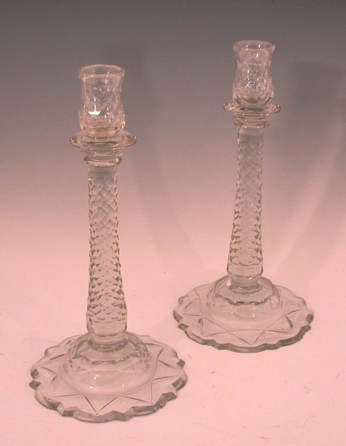 A pair of Regency glass candlesticks,