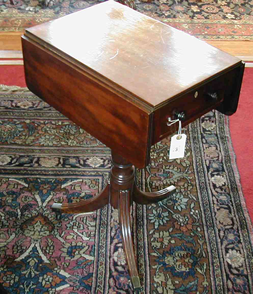 An early 19th century mahogany work table,