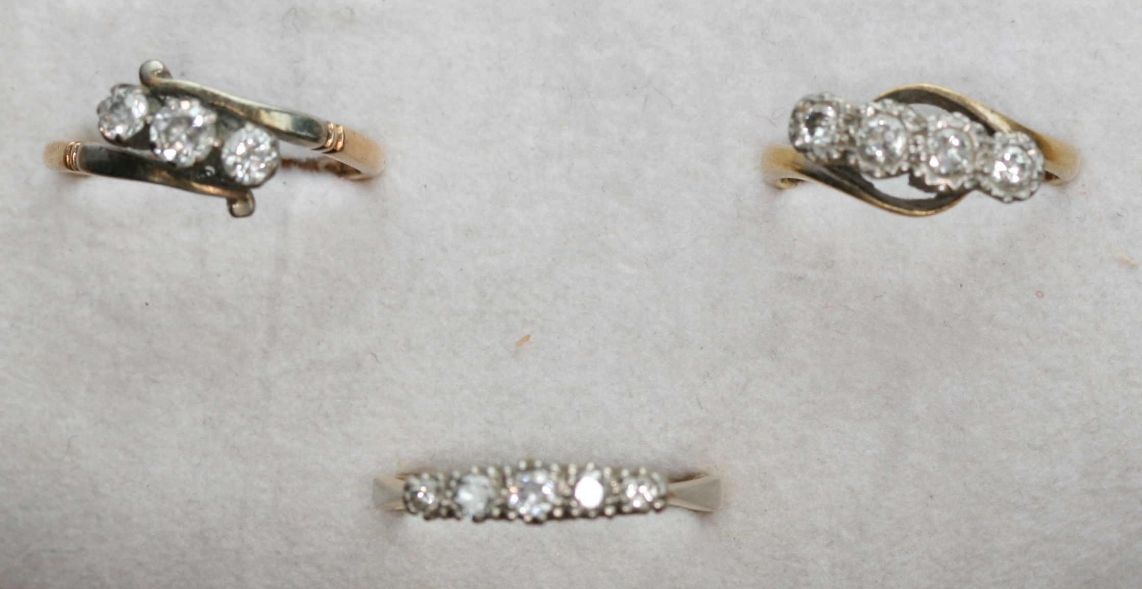 A group of three diamond set rings