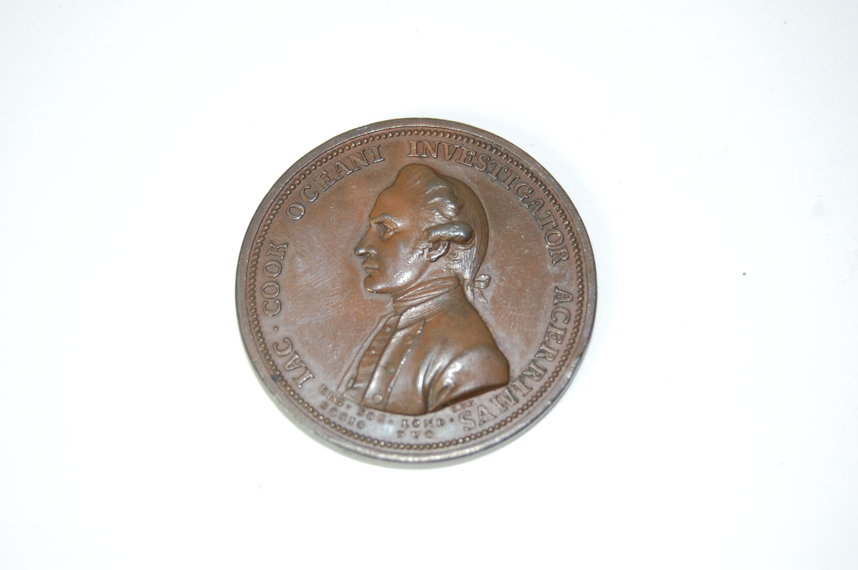 A bronze Cook medallion